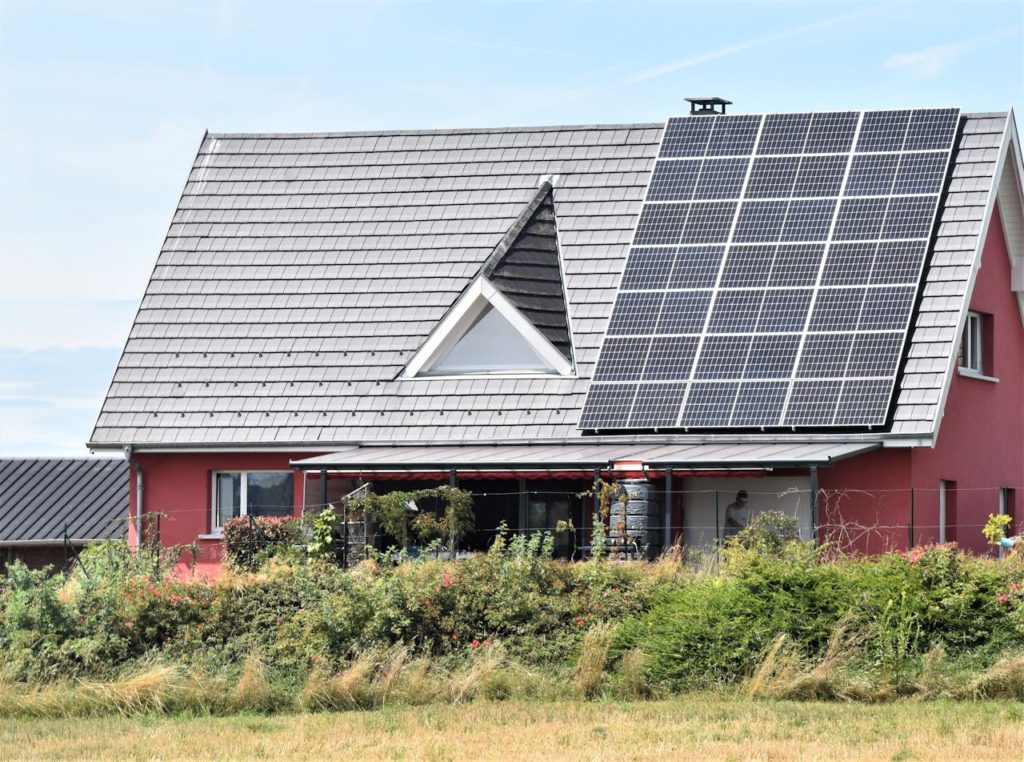 text: A house with solar panels installed marking the start of a self-sufficient life in the Virginia countryside